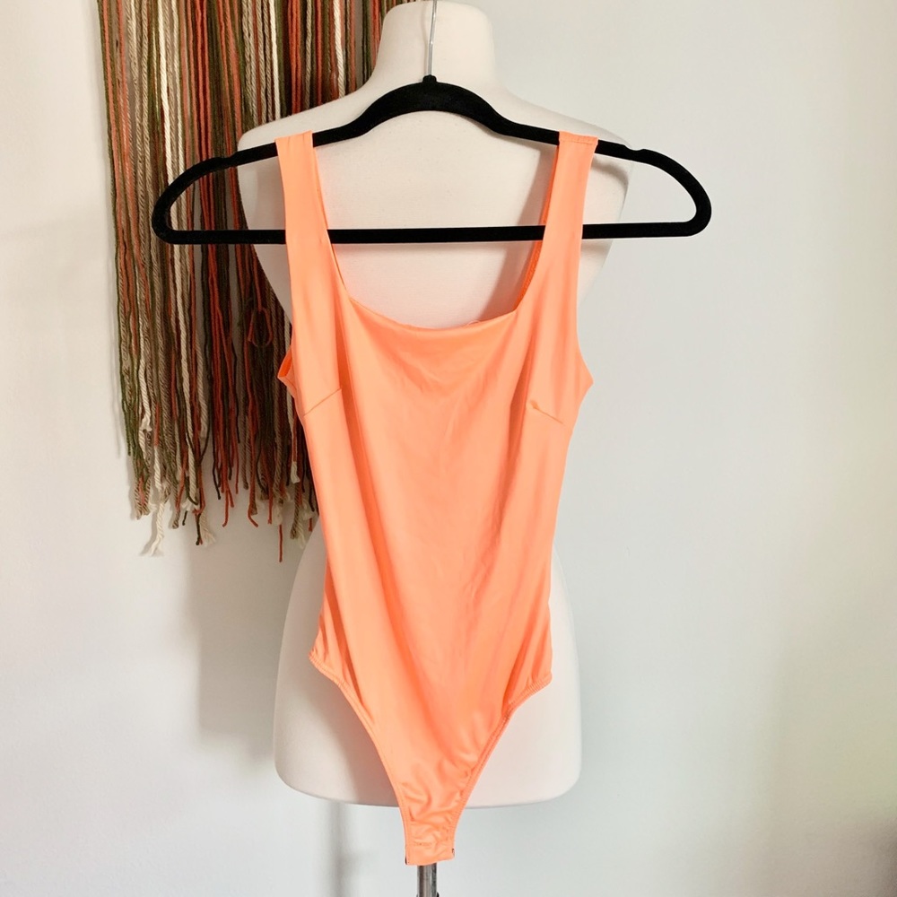 Neon orange body suit